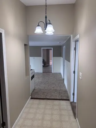 a view of a hallway with a chandelier