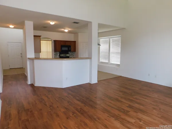a living room with hard wood floors and a wooden floor