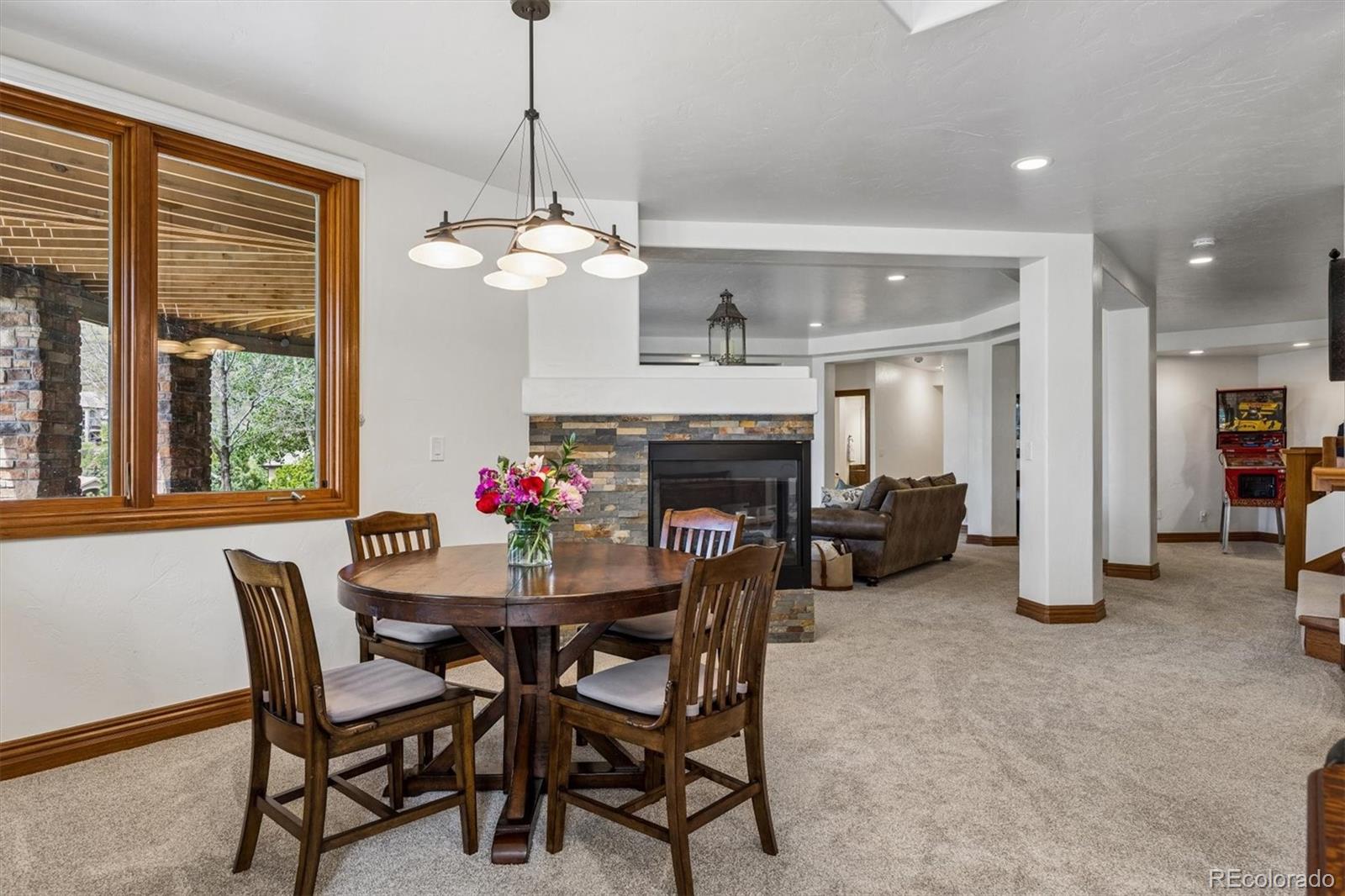 16422 Rocky Point Lane Morrison, CO 80465 - Photo 31 of 50 a view of a dining room with furniture window and wooden floor