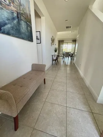 a living room with a couch and a stove top oven