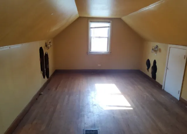 a view of a hallway with wooden floor and stairs