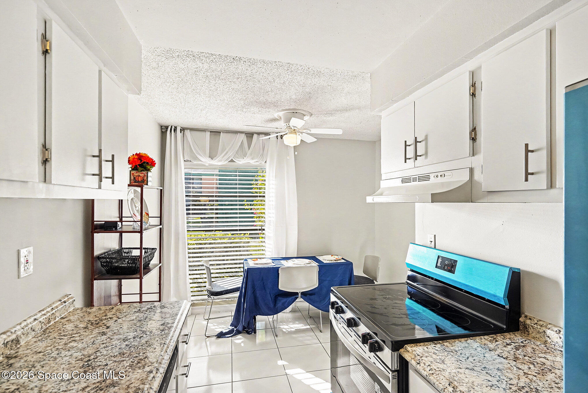 1225 North Wickham Road, Unit 411 Melbourne, FL 32935 - Photo 11 of 26 a living room with furniture and a table