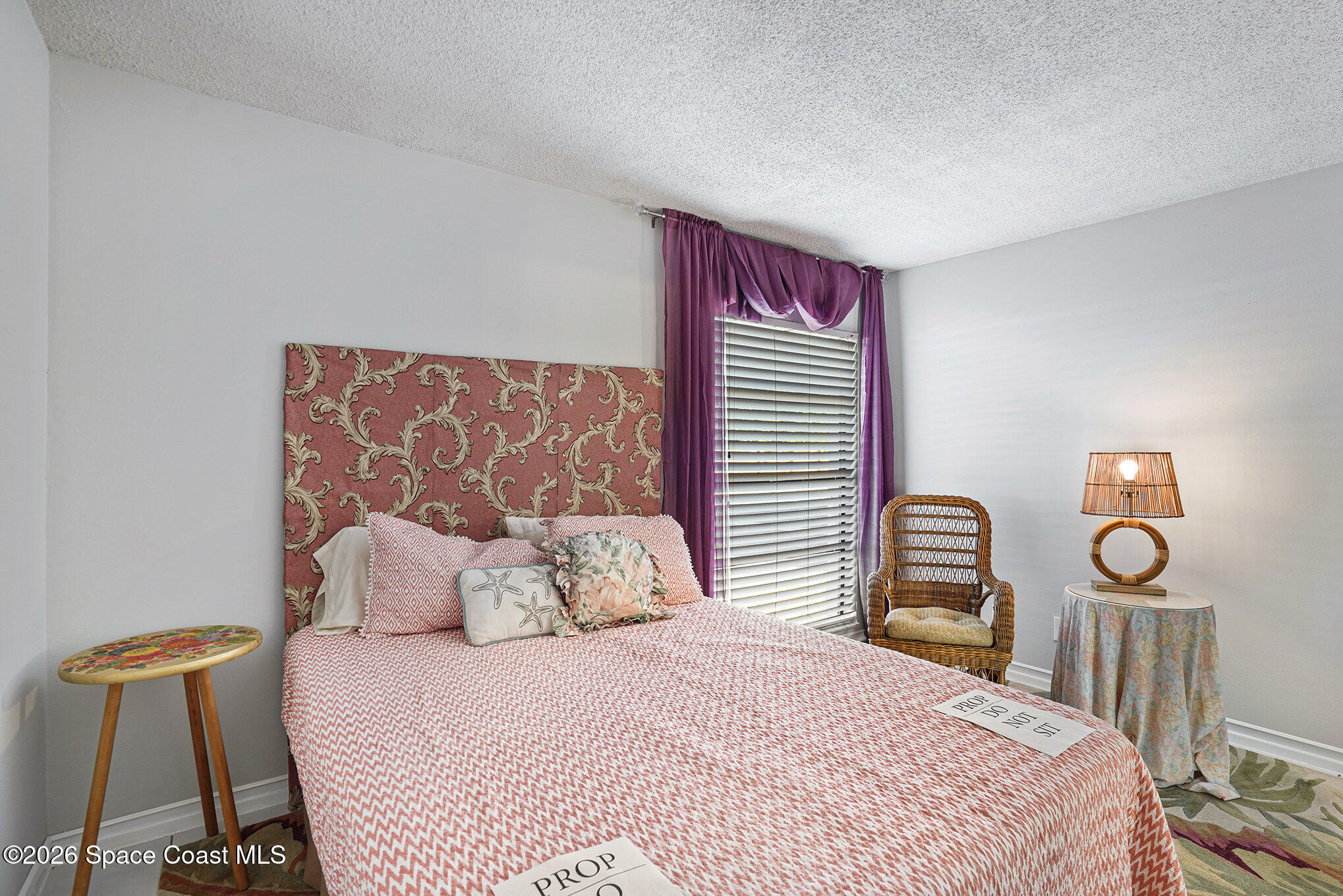 1225 North Wickham Road, Unit 411 Melbourne, FL 32935 - Photo 16 of 26 a bedroom with a bed and chair