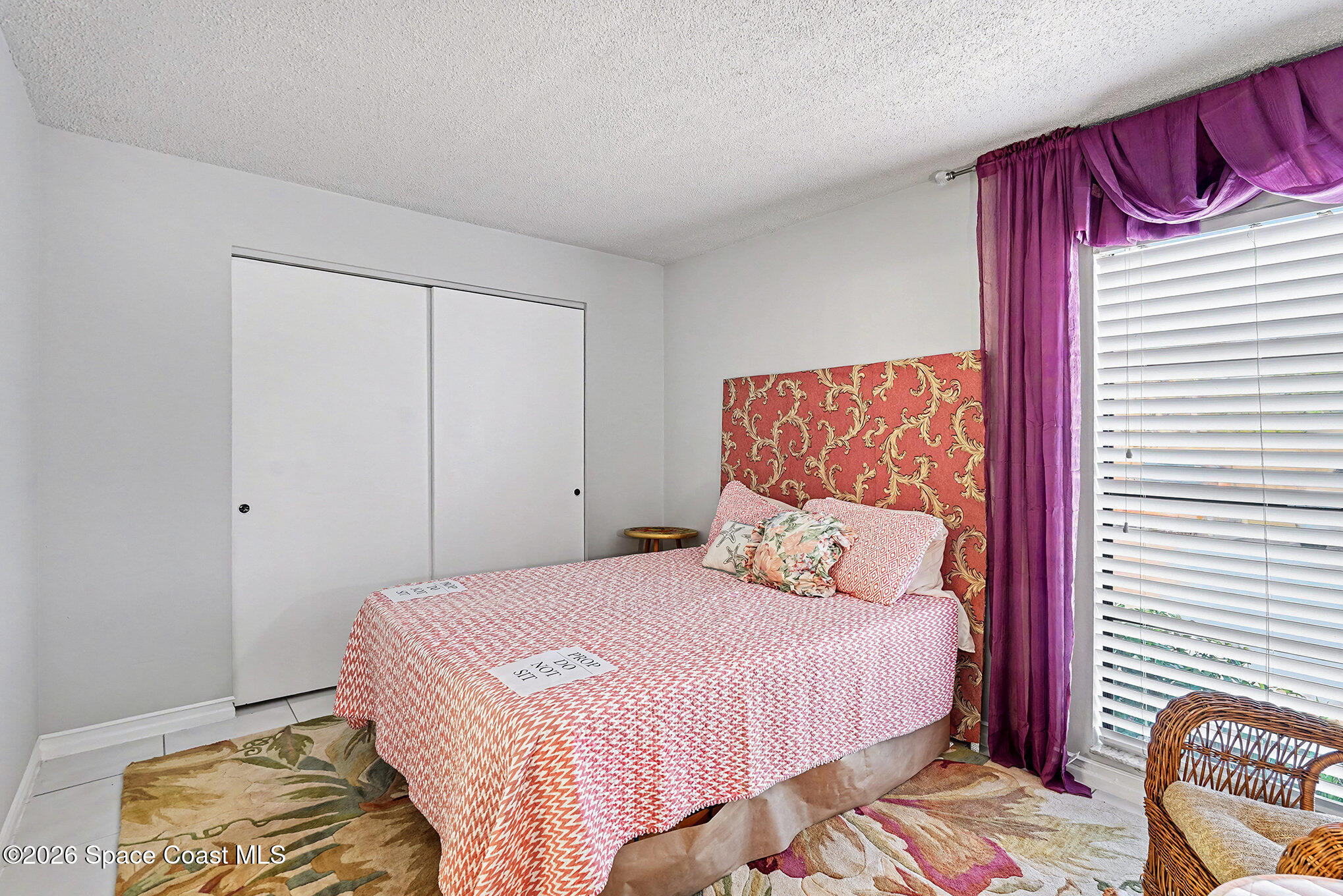 1225 North Wickham Road, Unit 411 Melbourne, FL 32935 - Photo 17 of 26 a bedroom with a bed and a painting on the wall