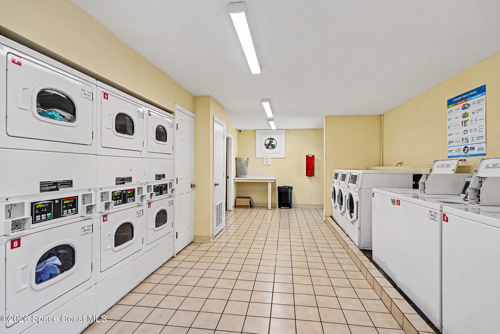 1225 North Wickham Road, Unit 411 Melbourne, FL 32935 - Photo 20 of 26 a view of kitchen with white cabinets