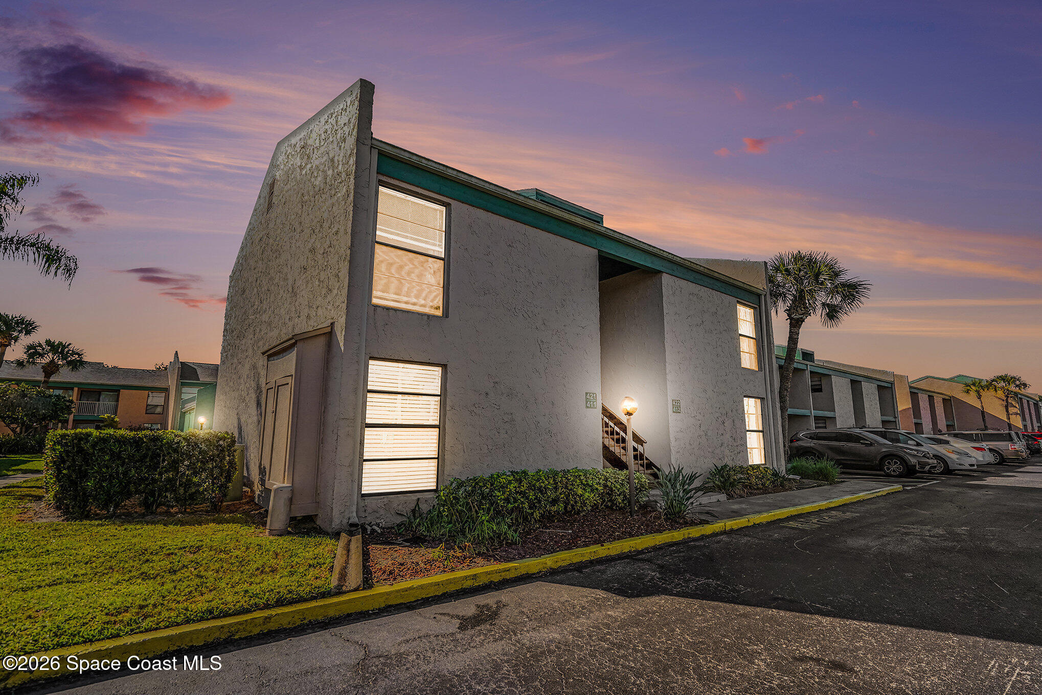 1225 North Wickham Road, Unit 411 Melbourne, FL 32935 - Photo 2 of 26 a front view of a house with a yard