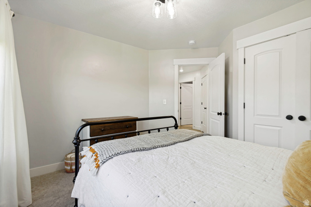 983 West 1550th Street South Springville, UT 84663 - Photo 28 of 43 Bedroom featuring light gray wall paint, white trim, and light gray carpet flooring.