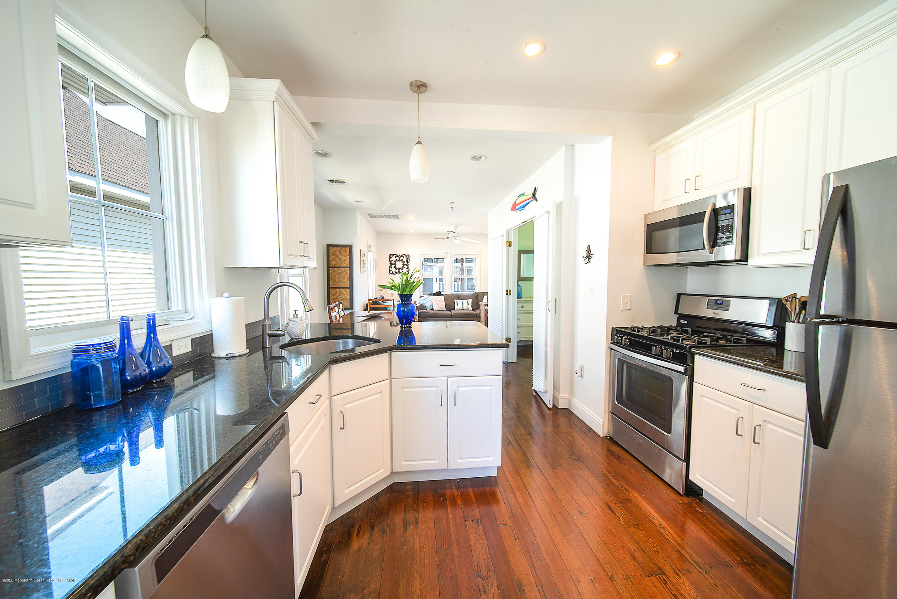 22 Cornwall Street Highlands, NJ 07732 - Photo 3 of 24 a large kitchen with stainless steel appliances granite countertop a large stove a sink dishwasher and a refrigerator with wooden floor