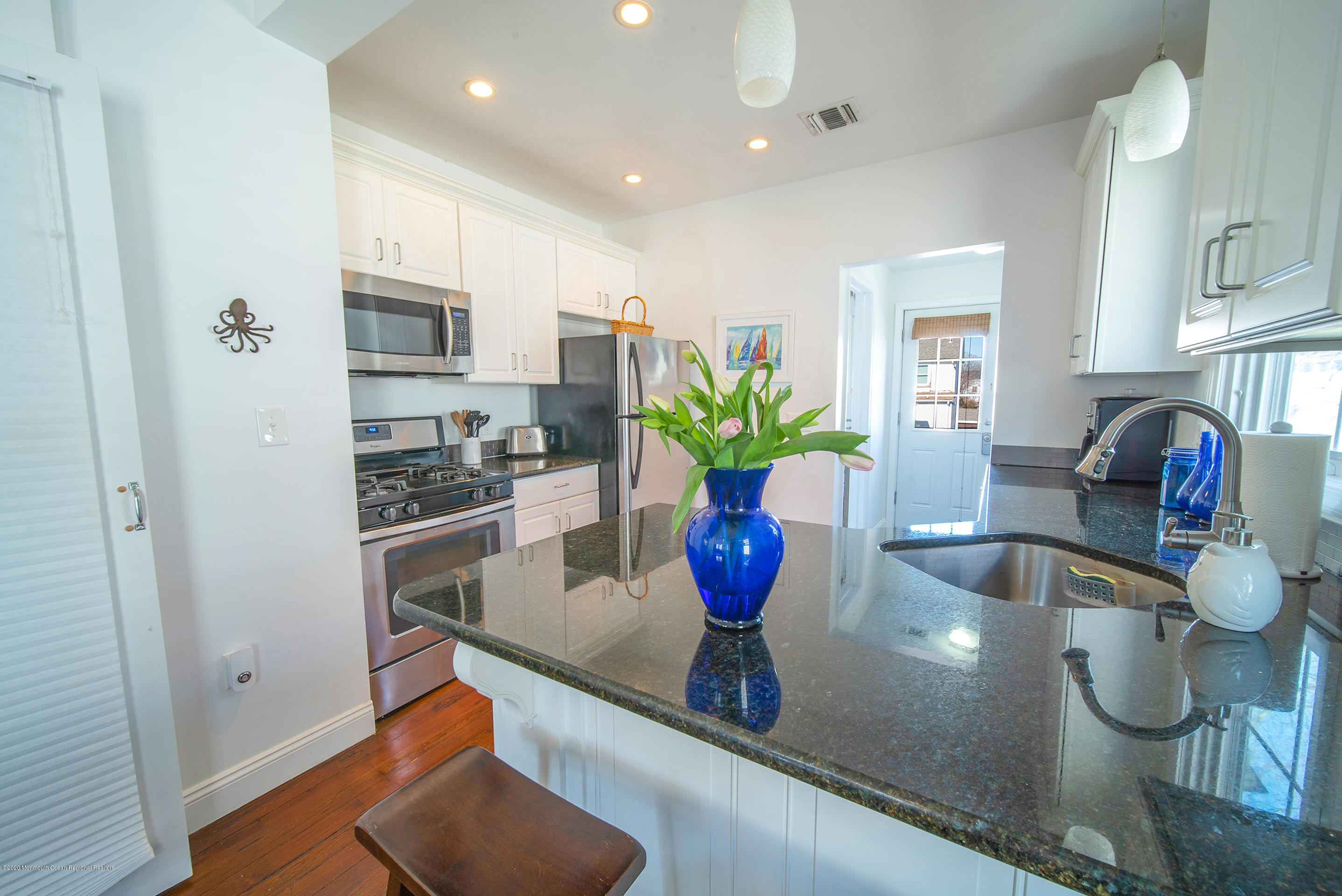 22 Cornwall Street Highlands, NJ 07732 - Photo 4 of 24 a kitchen with stainless steel appliances granite countertop a sink a refrigerator and a granite counter tops