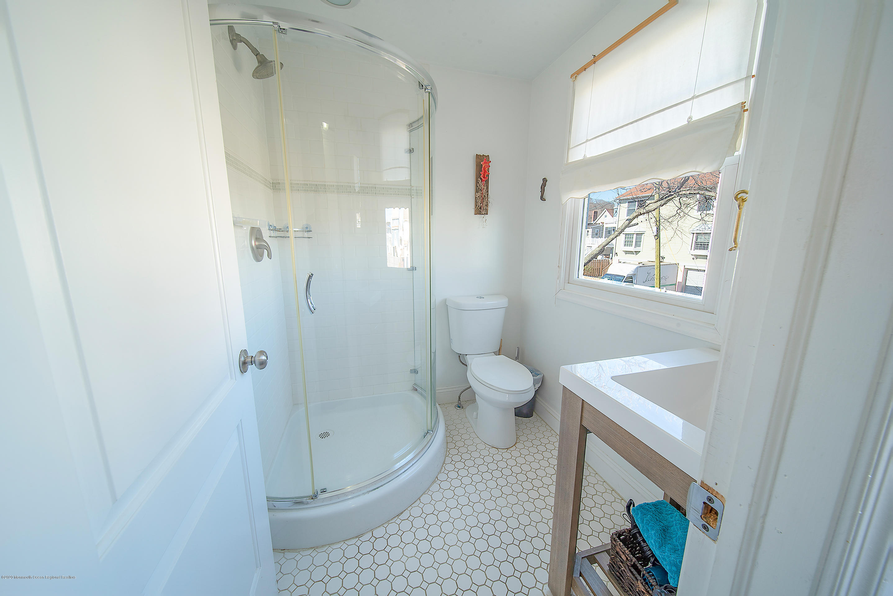22 Cornwall Street Highlands, NJ 07732 - Photo 9 of 24 a bathroom with a sink a toilet and shower