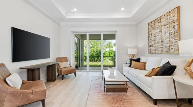 a kitchen with stainless steel appliances a refrigerator a sink dishwasher a stove and white cabinets with wooden floor