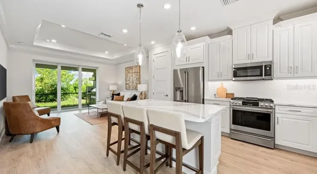 a kitchen with a stove a sink and a refrigerator