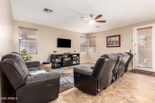 a dining room with furniture a chandelier and window