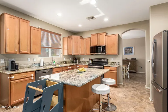 a kitchen with stainless steel appliances granite countertop a refrigerator stove microwave and sink