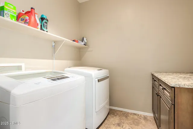 a view of a patio with a table and chairs under an umbrella
