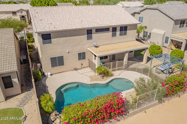 an aerial view of residential houses with outdoor space and parking