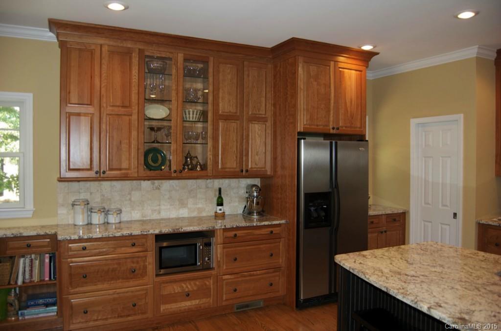 190 Kimberly Road Davidson, NC 28036 - Photo 11 of 21 a kitchen with granite countertop a refrigerator and cabinets