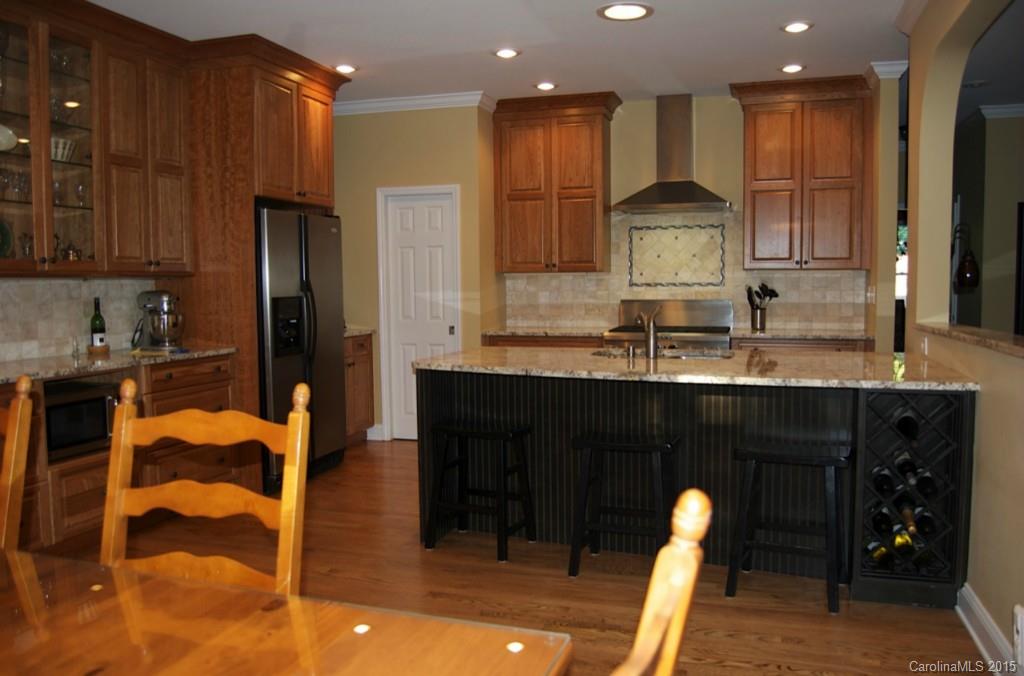 190 Kimberly Road Davidson, NC 28036 - Photo 13 of 21 a kitchen with stainless steel appliances kitchen island granite countertop a refrigerator and cabinets