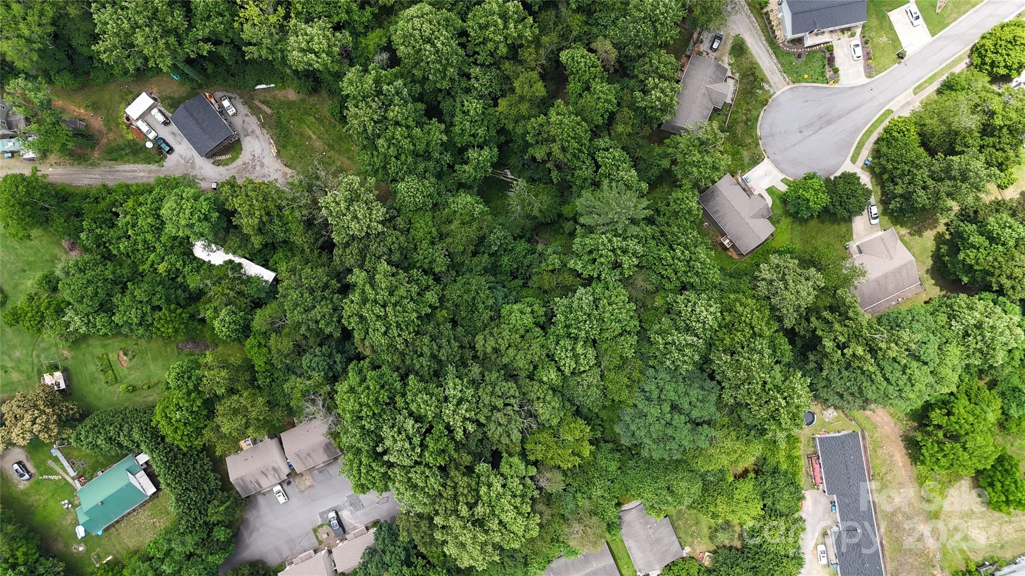 a backyard of a house with a yard and outdoor seating