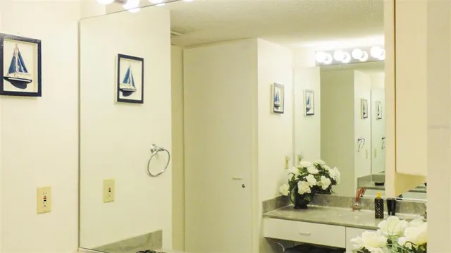 a bathroom with a mirror shower and a sink