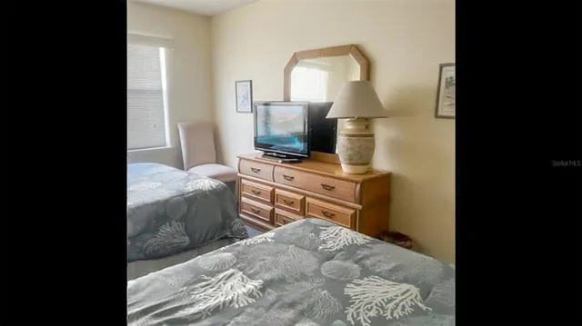 a bedroom with a bed and a mirror