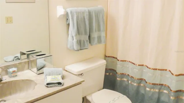 a white toilet sitting next to a bathroom sink