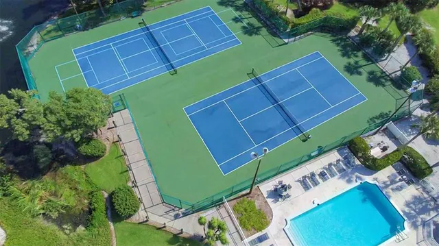 a green field with some trees in the background
