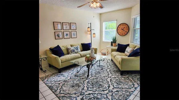 a living room with furniture and a clock