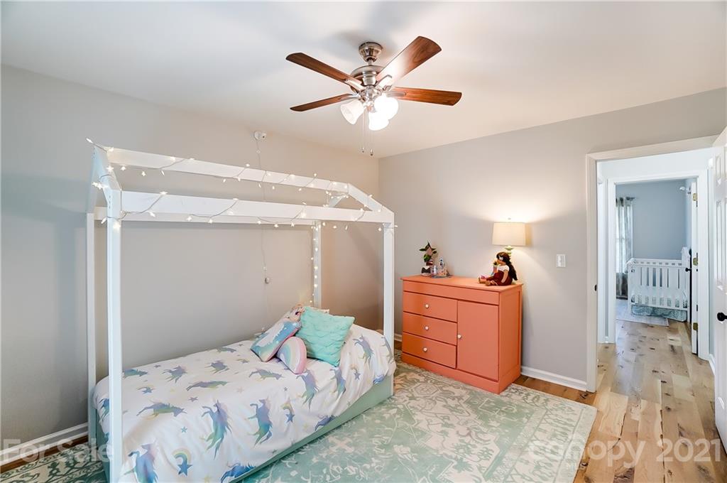 2375 Whitley Road Fort Mill, SC 29708 - Photo 24 of 35 a bedroom with a bed and a chandelier
