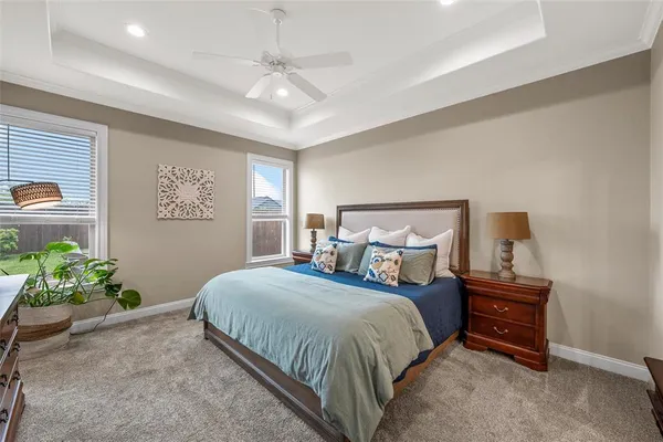 a bedroom with a bed and a chandelier