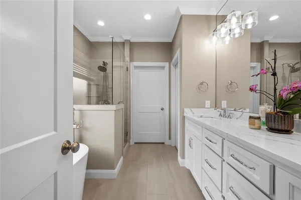 a bathroom with a double vanity sink mirror and shower