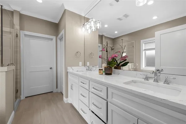 a bathroom with a double vanity sink and a mirror
