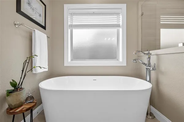 a white bath tub sitting next to a window