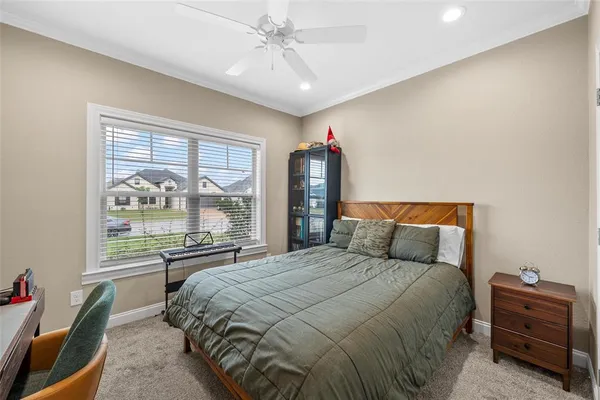 a bedroom with a large bed and a window