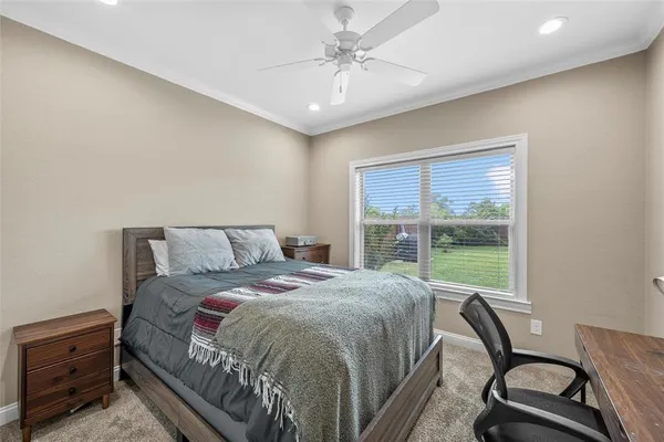 a bed sitting in a bedroom next to a window