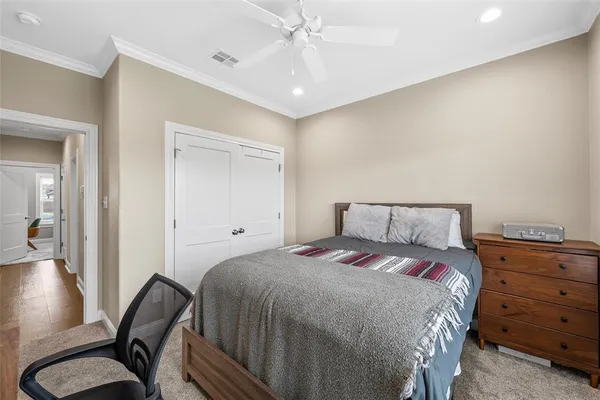a bedroom with a bed and a chair