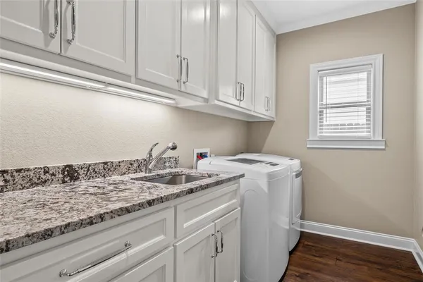 a view of a sink and dishwasher with wooden floor