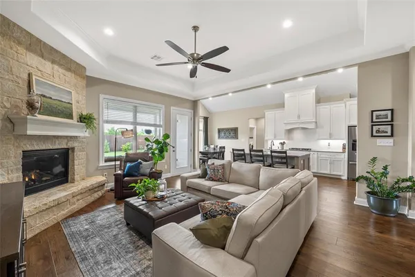a living room with furniture fireplace and a large window