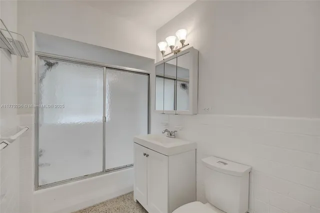 a bathroom with a shower a mirror and a sink