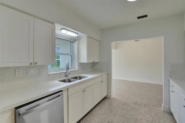 a kitchen with a sink and cabinets