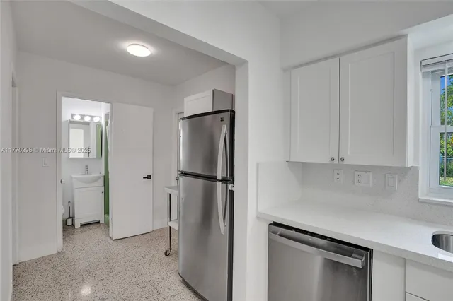 a kitchen with a refrigerator and cabinets
