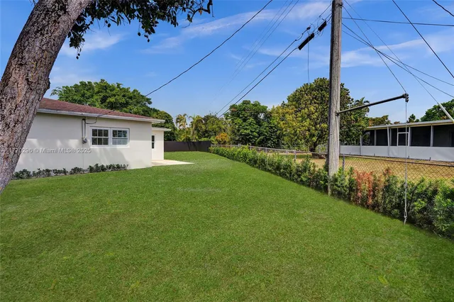 a view of a house with a backyard