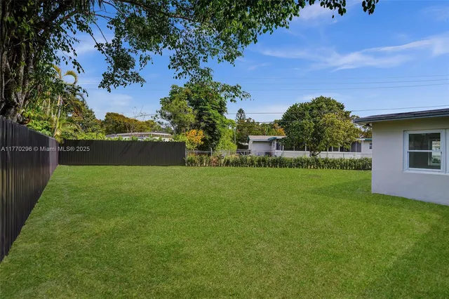 a view of yard with swimming pool and green space