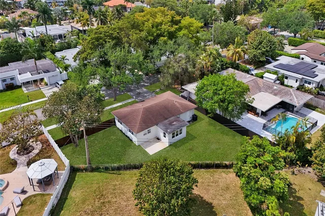an aerial view of multiple houses with yard