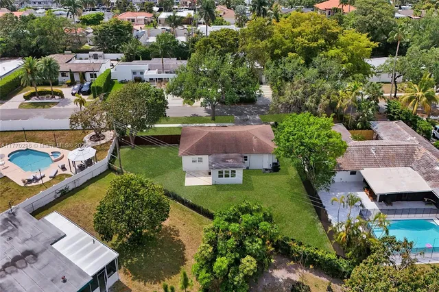 an aerial view of multiple houses with yard
