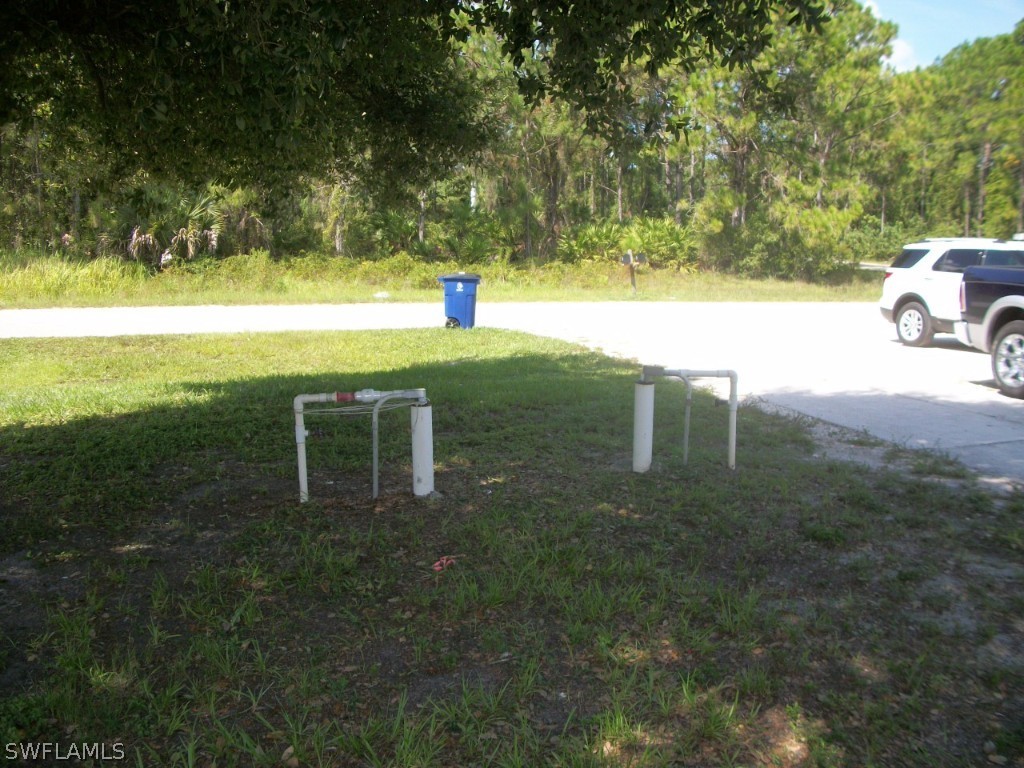 801 Meadow Road Lehigh Acres, FL 33973 - Photo 8 of 13 a view of a field with an trees