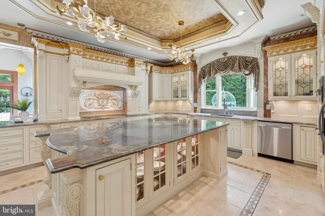 a kitchen with stainless steel appliances kitchen island granite countertop a refrigerator and a sink