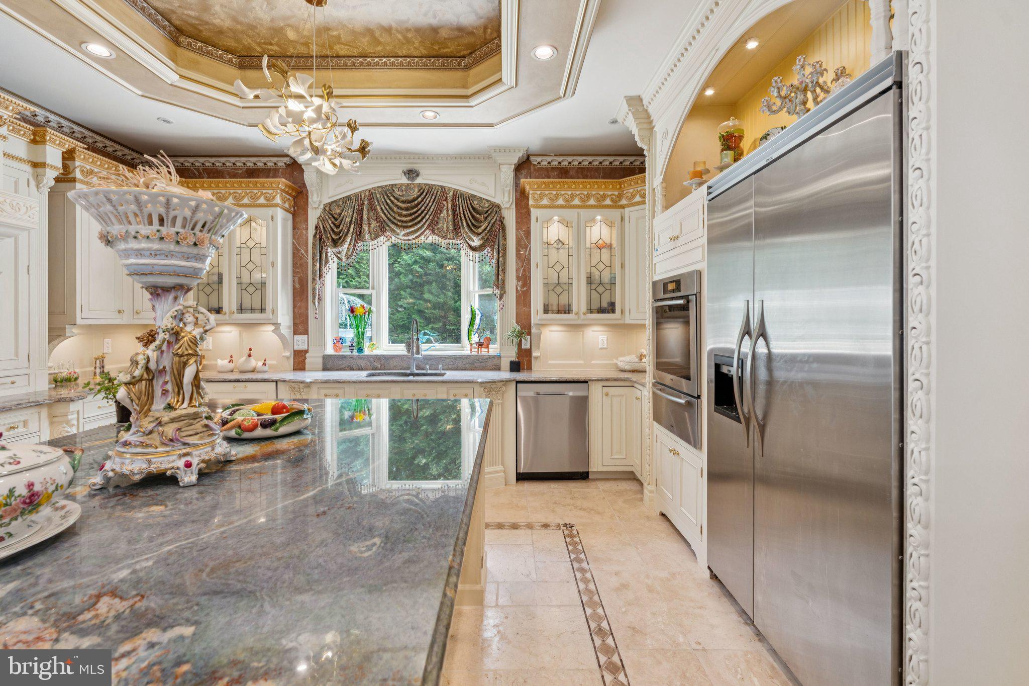 423 Seneca Road Great Falls, VA 22066 - Photo 16 of 52 a kitchen with stainless steel appliances kitchen island granite countertop a refrigerator and a sink