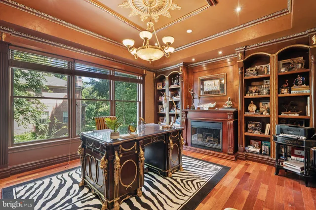 a spacious bedroom with a bed and a chandelier