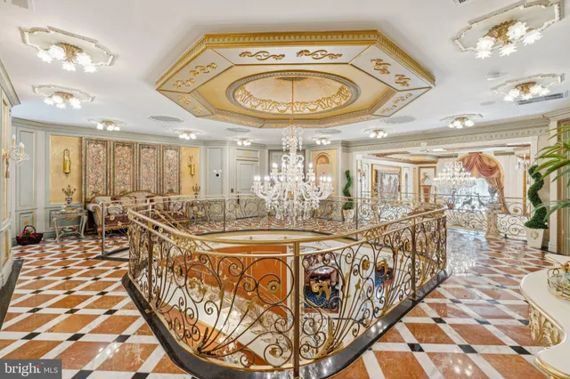 a spacious bedroom with a large bed and a chandelier